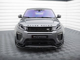 A gray Range Rover with sleek headlights faces forward, parked on a tiled floor. The text 