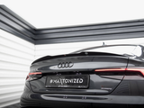 A sleek Audi car is parked in a modern, well-lit showroom. The license plate reads 
