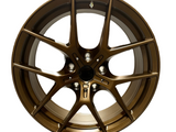 Bronze alloy wheel with a multi-spoke design, positioned upright against a plain, white background.
