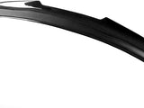A curved, black carbon fiber car spoiler with a glossy finish rests against a plain white background, showcasing its aerodynamic design and texture.