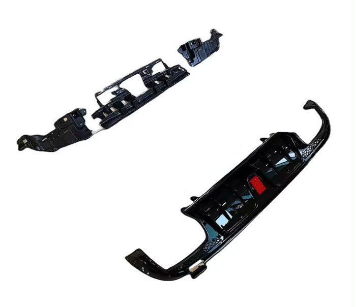 Black car bumpers are laid out separately on a plain white background, showcasing their curved and angular design features.