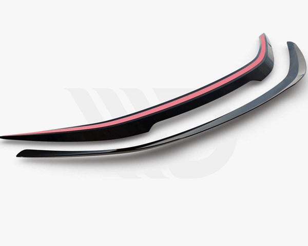 Two sleek, curved aerodynamic car spoilers are placed side by side on a white background. The upper spoiler features a red stripe. Bottom text reads: "WORLDWIDE LEADER IN AERODYNAMIC COMPONENTS."