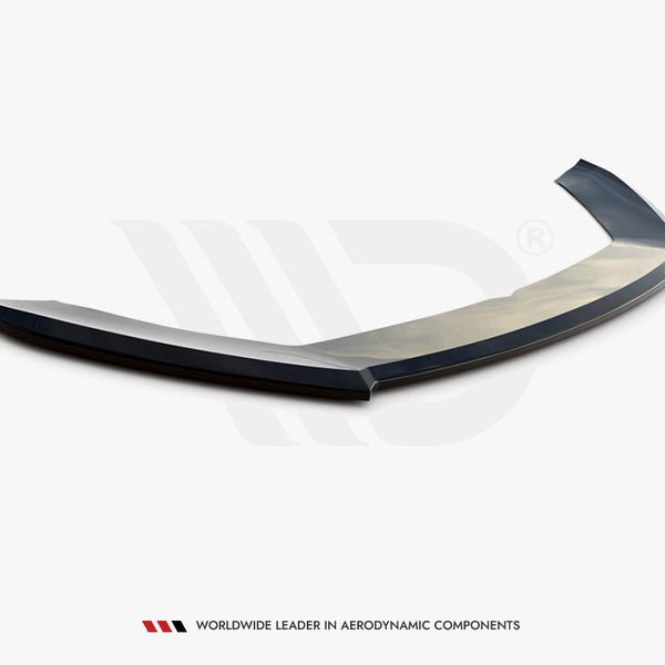 Curved aerodynamic car spoiler lies on a plain surface. Text below reads, “WORLDWIDE LEADER IN AERODYNAMIC COMPONENTS.” It features sleek design elements positioned in a minimalist environment.
