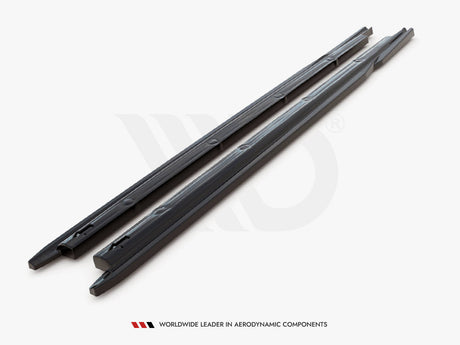 Two black, elongated plastic strips lie parallel on a white surface, likely used for aerodynamic purposes. Text below reads, "WORLDWIDE LEADER IN AERODYNAMIC COMPONENTS."