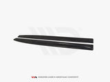 Two black, elongated aerodynamic car components lie parallel on a plain white background. Text reads: 