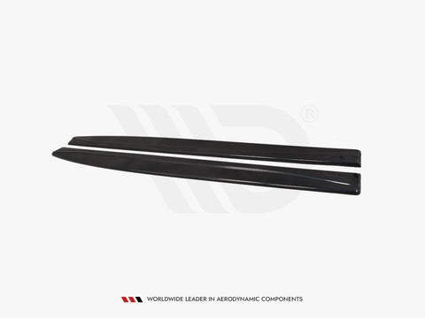 Two black, elongated aerodynamic car components lie parallel on a plain white background. Text reads: "WORLDWIDE LEADER IN AERODYNAMIC COMPONENTS."