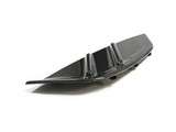 A sleek, black carbon fiber car rear diffuser with vertical fins rests on a white surface, suggesting its use for aerodynamic enhancement.