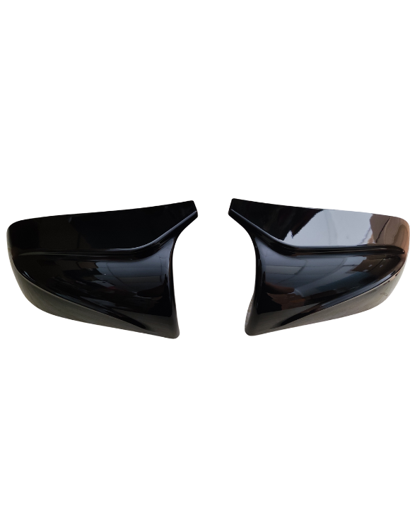 Two black car mirror covers face each other, slightly tilted inward, against a plain white background.