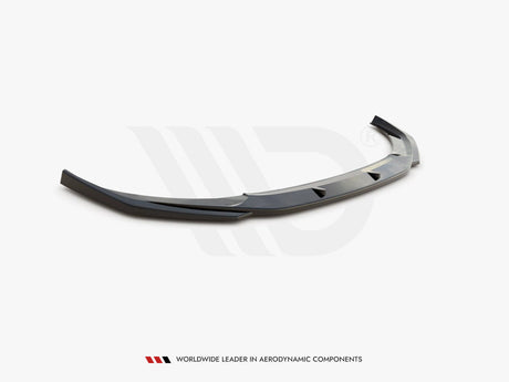 A sleek, dark gray car spoiler rests on a plain white surface, designed for aerodynamic enhancement. Text below reads: "WORLDWIDE LEADER IN AERODYNAMIC COMPONENTS."