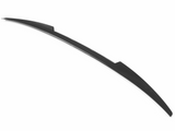 A black, curved car spoiler sits against a white background, showcasing its aerodynamic profile with smooth lines and a streamlined shape.