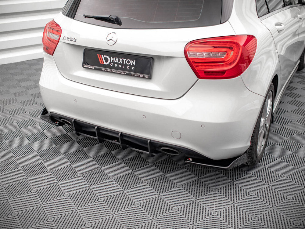 A white Mercedes-Benz A250 is parked on a patterned gray floor, displaying its rear view. The license plate reads "MAXTON design," indicating customization by Maxton Design.