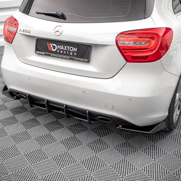 A white Mercedes-Benz A250 is parked on a patterned gray floor, displaying its rear view. The license plate reads "MAXTON design," indicating customization by Maxton Design.