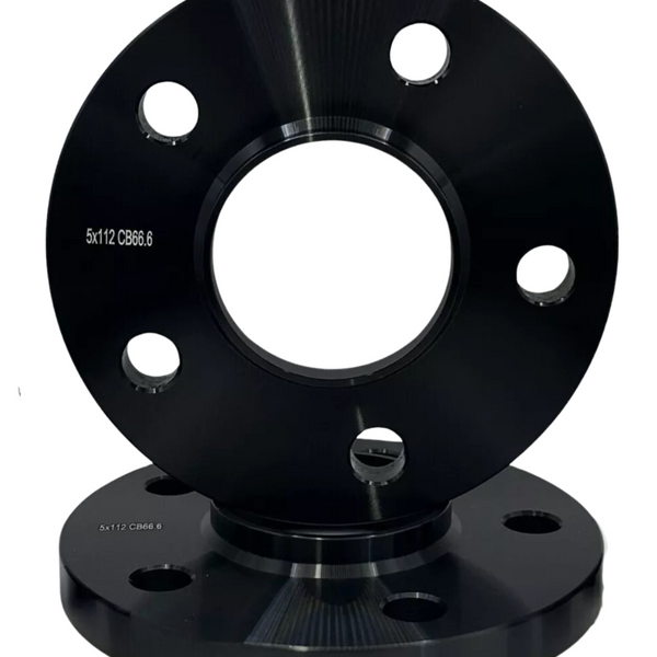 Two black wheel spacers, each with multiple holes, are stacked vertically. The top spacer displays the text "5x112 CB66.6" on a plain white background.