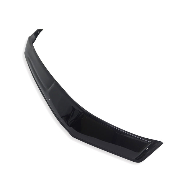 A glossy black car spoiler lies diagonally on a plain white background, showcasing its sleek, curved design and aerodynamic structure.
