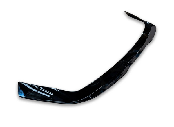 A shiny black car bumper, slightly curved, rests against a plain white background.