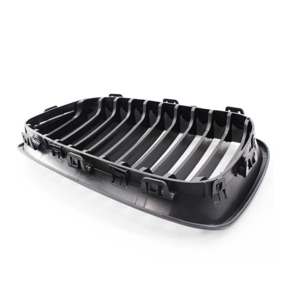 A black plastic car grille featuring horizontal slats and clips, designed for installation on a vehicle, displayed against a plain white background.