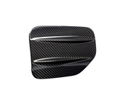 A sleek, carbon fiber car accessory with two aerodynamic ridges, set against a plain white background, showcasing its glossy textured pattern.