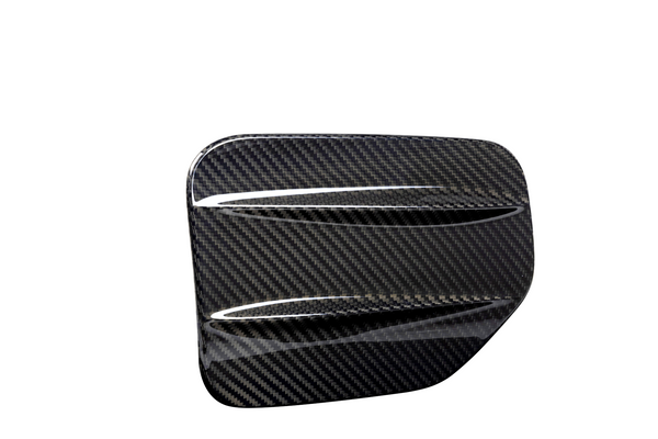 A sleek, carbon fiber car accessory with two aerodynamic ridges, set against a plain white background, showcasing its glossy textured pattern.
