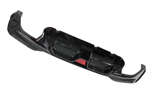 A glossy black car bumper with aerodynamic contours and a central red reflector, displayed against a white background.