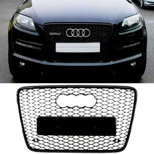 A black Audi car with a prominent front grille displays the brand's logo and a blank license plate space; below, a detached honeycomb-style Audi grille is shown against a plain background.