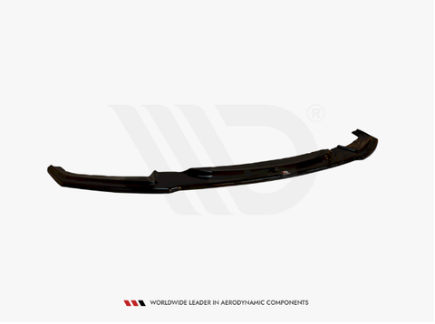 A black aerodynamic car component, possibly a spoiler or bumper lip, laying horizontally against a plain white background. Text reads "WORLDWIDE LEADER IN AERODYNAMIC COMPONENTS."