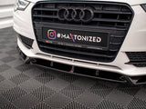 Car's front grille with Audi logo and license plate displaying text 