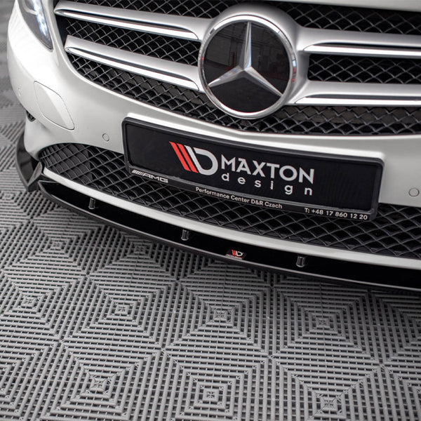 A car grille with a prominent emblem and "MAXTON design" plate is displayed. The vehicle is parked on a patterned, textured floor. Additional text: "Performance Center D&R Czach T: +48 17 860 12 20."