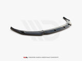Curved, glossy black car spoiler with angular design, resting on a plain surface. Text below reads: 