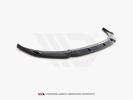 Curved, glossy black car spoiler with angular design, resting on a plain surface. Text below reads: "WORLDWIDE LEADER IN AERODYNAMIC COMPONENTS."