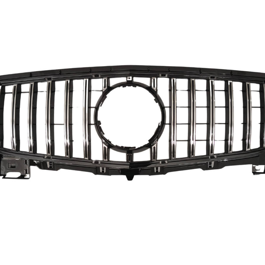 Chrome vehicle grille with vertical slats and a central circular emblem space, resting on a plain white background, displaying a sleek and modern design.