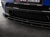 Car front bumper exhibits a black grille. A license area displays text: 