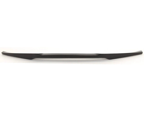 A long, sleek, black object, possibly an automotive accessory or trim piece, lies horizontally against a plain white background.