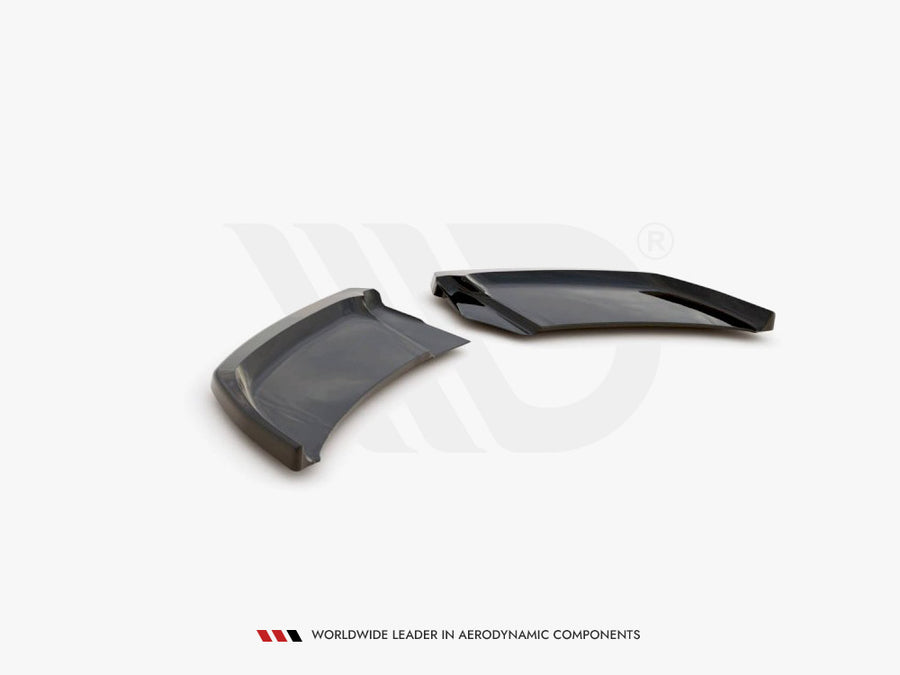 Two sleek, aerodynamic black plastic components rest on a white surface, angled adjacent to each other. Text below reads: "WORLDWIDE LEADER IN AERODYNAMIC COMPONENTS."