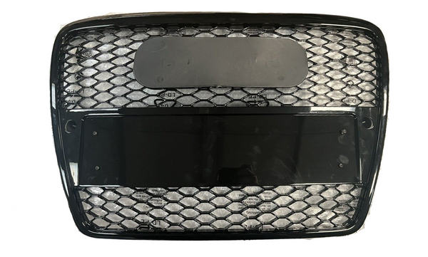 A black, rectangular grille with hexagonal mesh inserts is positioned on a white background. The grille features two rectangular sections, one obscured by a dark, reflective panel.