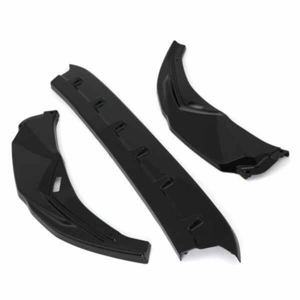 Three black car parts, possibly aerodynamic components, are arranged on a white background. Two pieces are angled with a geometric design, and one is a straight, ribbed section.