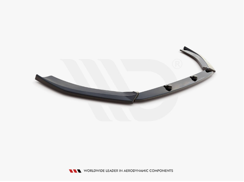 A sleek black aerodynamic car component lies on a white background with subtle logo watermarking, featuring mounting points. Text at the bottom reads: "WORLDWIDE LEADER IN AERODYNAMIC COMPONENTS."