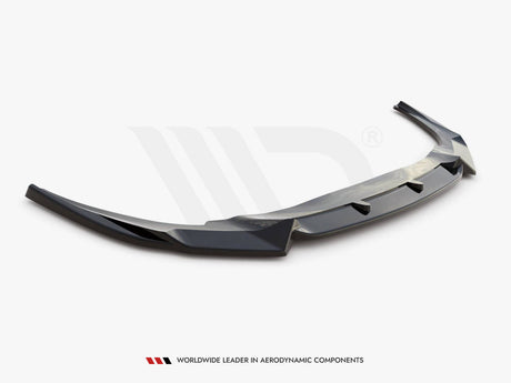 A sleek, black aerodynamic car spoiler is shown, extending horizontally with angled edges. It rests on a plain white background. Text reads: "WORLDWIDE LEADER IN AERODYNAMIC COMPONENTS."