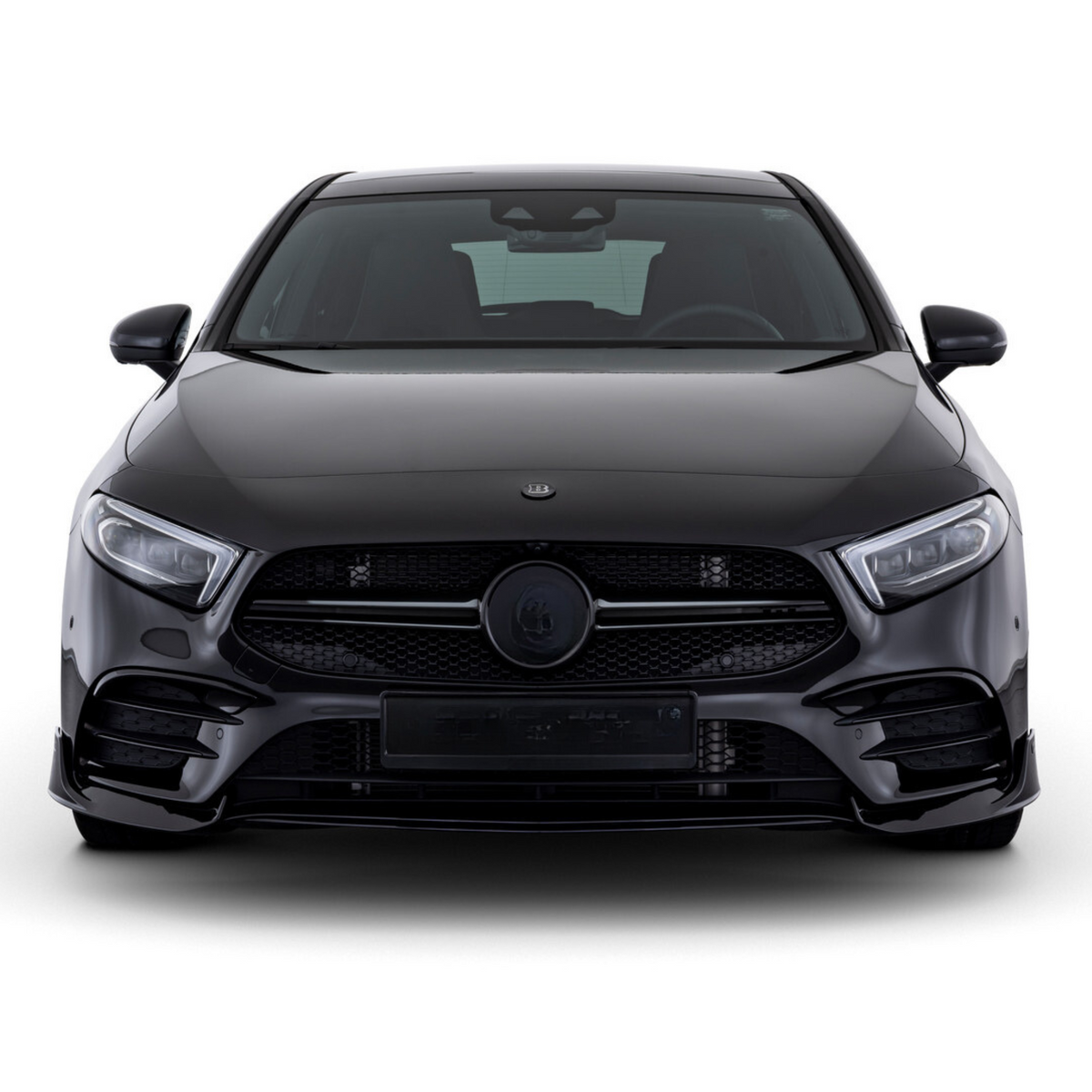 A sleek, black car is stationary, facing forward, showcasing its bold grille and headlights in a studio setting.