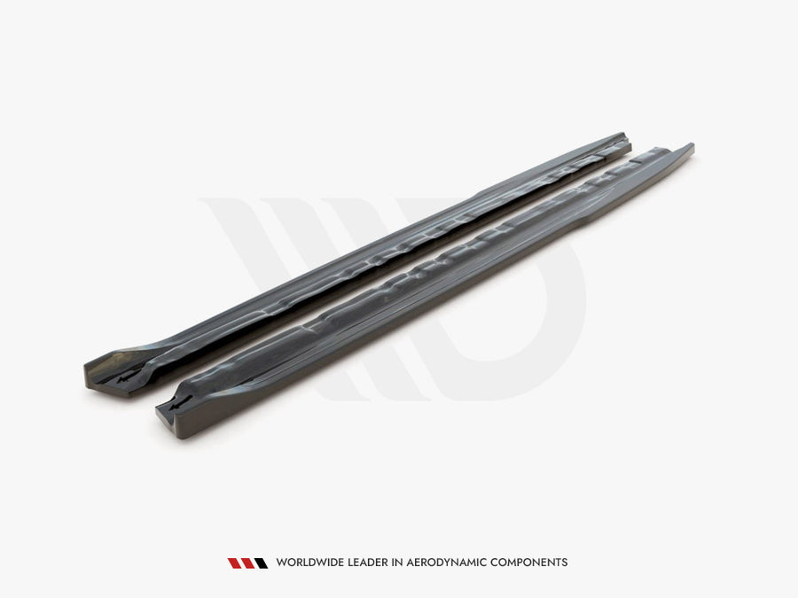 Two long, sleek car components are placed parallel on a plain surface. The text reads, "WORLDWIDE LEADER IN AERODYNAMIC COMPONENTS."