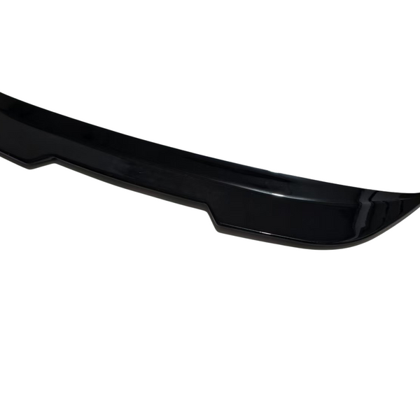 A sleek, black car spoiler displayed in isolation on a white background, showcasing its aerodynamic design with curved edges.