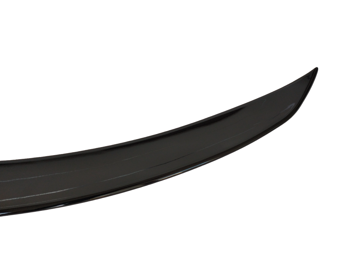 A shiny black car spoiler is displayed against a plain white background, showing its curved aerodynamic shape and glossy surface.