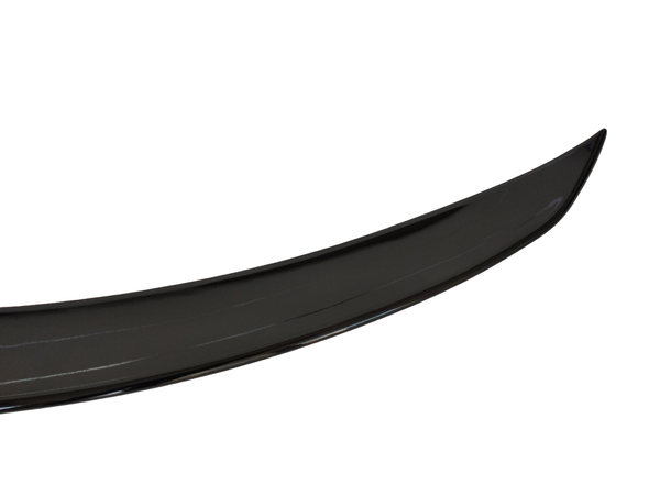 A shiny black car spoiler is displayed against a plain white background, showing its curved aerodynamic shape and glossy surface.