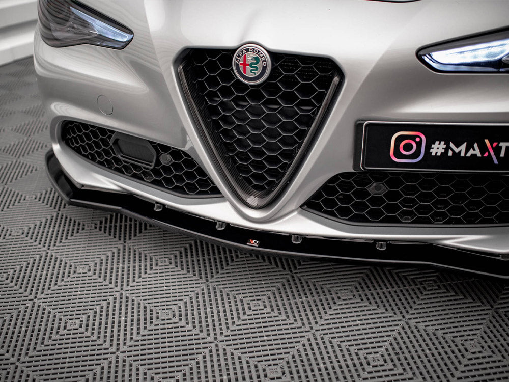 Car front with Alfa Romeo badge and honeycomb grille, parked on a patterned floor. License plate displays "@MAXTUNE" with Instagram logo.