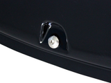 A metallic button surrounded by glossy black material is embedded in a dark, smooth surface, suggesting part of a vehicle's exterior.