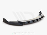 A black, aerodynamically designed car spoiler with angular edges rests against a plain white background. Text at the bottom reads, 