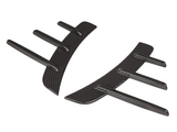 Two curved carbon fiber car diffusers with vertical fins, lying against a white background.