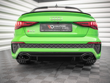 A bright green Audi RS3 is stationary on a checkered floor, viewed from the rear. The car features dual exhausts and a Maxton design plate. Surrounding walls are reflective and angular. Text on the plate reads: 