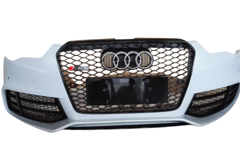 A car's front bumper features a black honeycomb grille with four interlocking rings and "RS5" emblem, set against a plain white background.