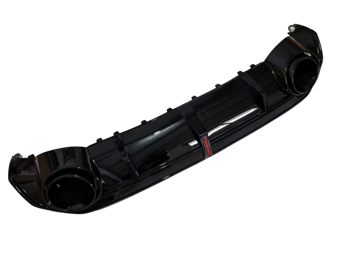 A glossy black car rear diffuser features integrated exhaust port areas, designed for aerodynamic enhancement, set against a plain white background.