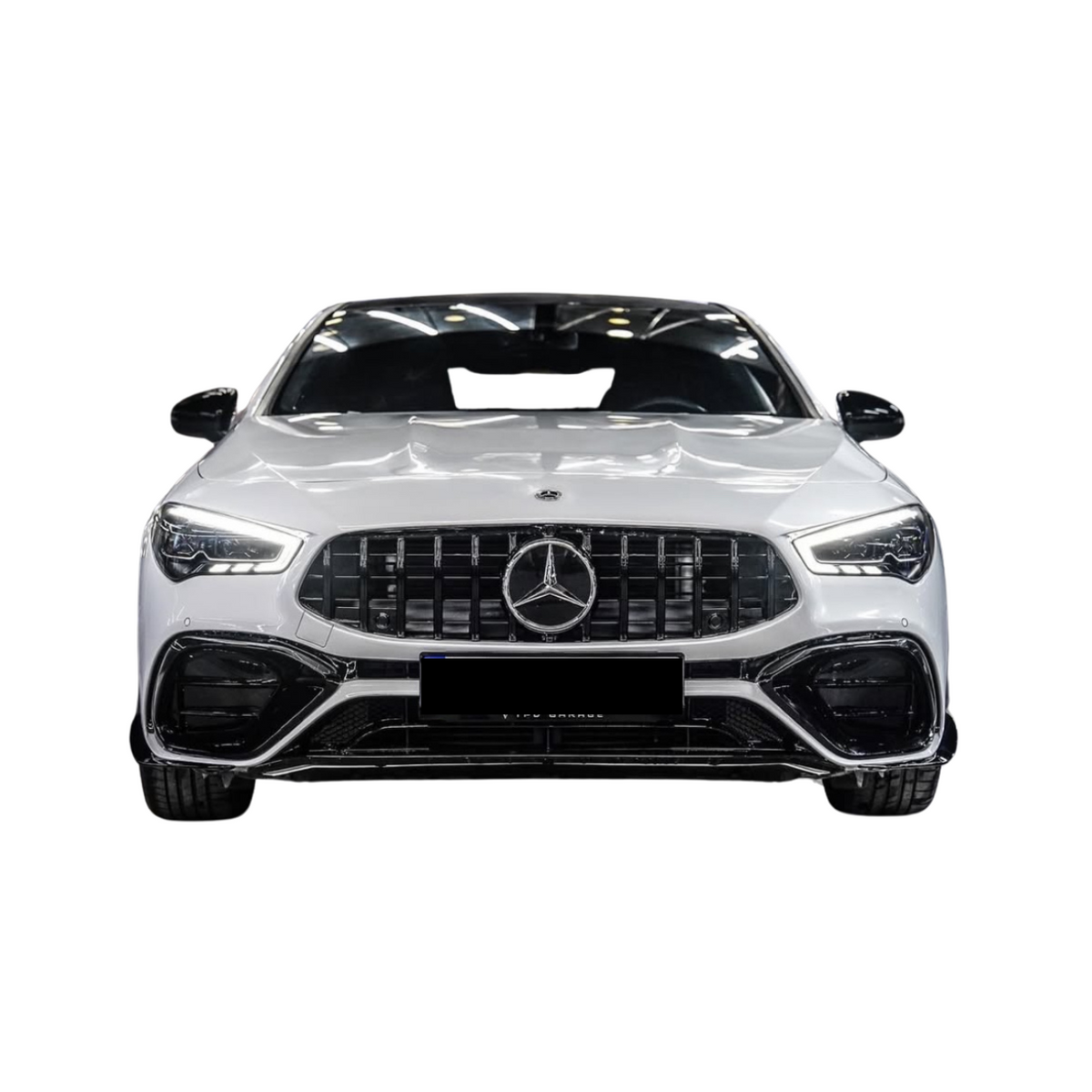 A white Mercedes-Benz car is displayed from the front, showcasing a prominent grille, sleek headlights, and a glossy finish in an isolated setting.